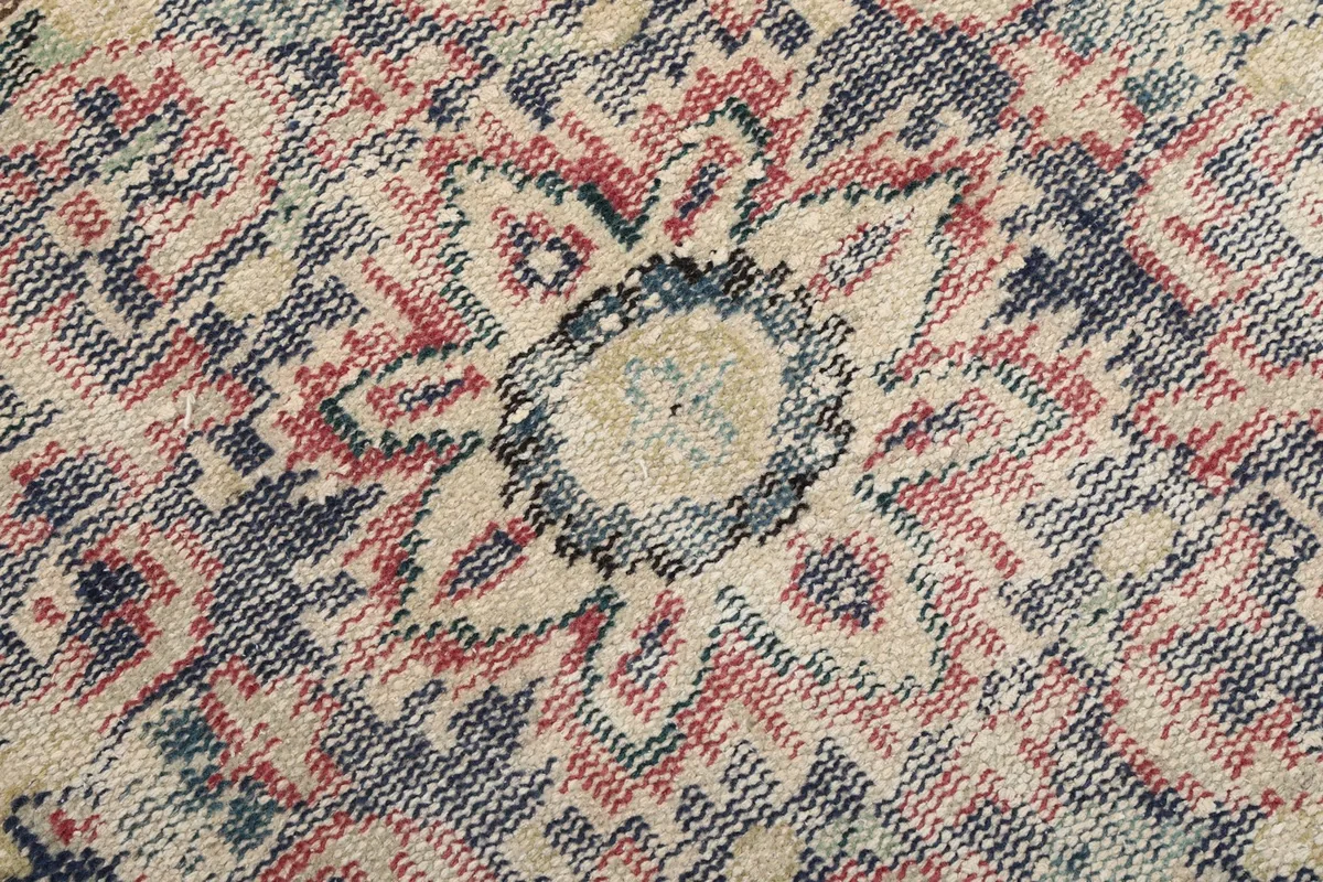 Close-up of the hand-knotted wool pile and intricate geometric patterns