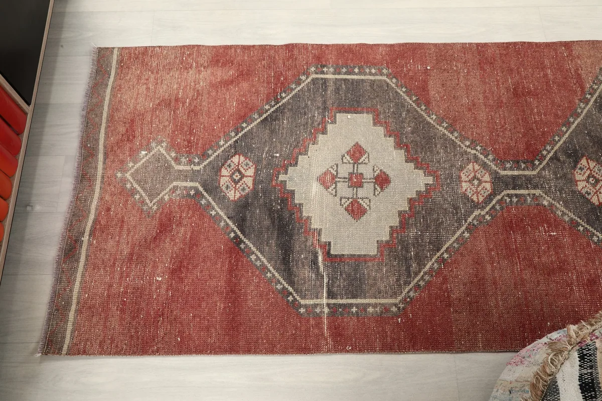 Top-down view of one end of the runner rug, showcasing the geometric design and texture.