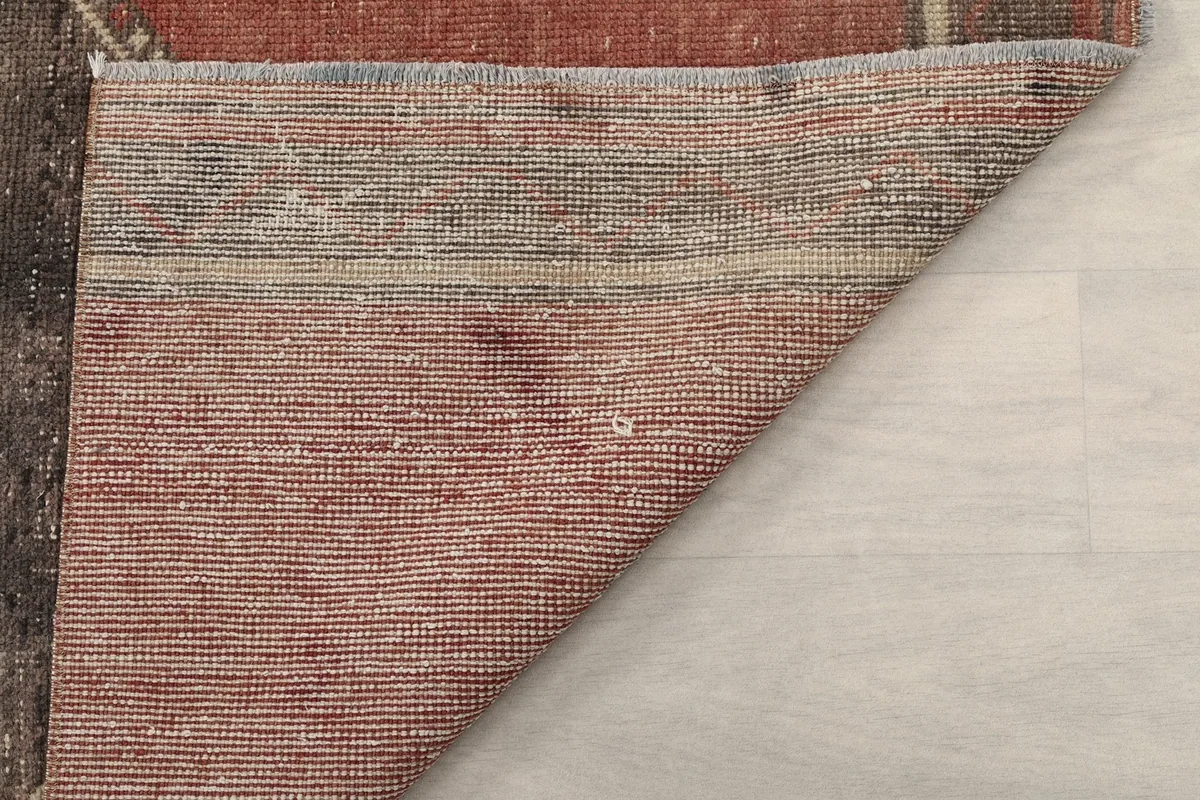 Detailed view of the reverse side of the runner rug, illustrating the weave and material.