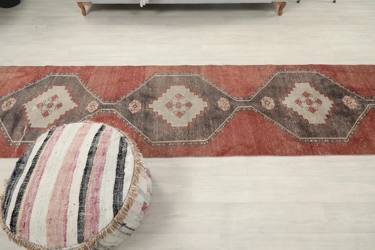 Wide overhead view of the runner rug stretched across a room, emphasizing its long length and pattern flow.