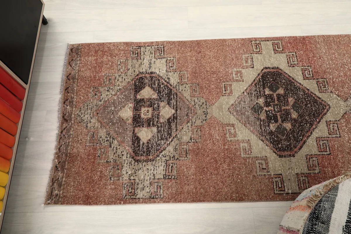 Overhead view focusing on a section of the runner, highlighting multiple geometric diamond motifs.