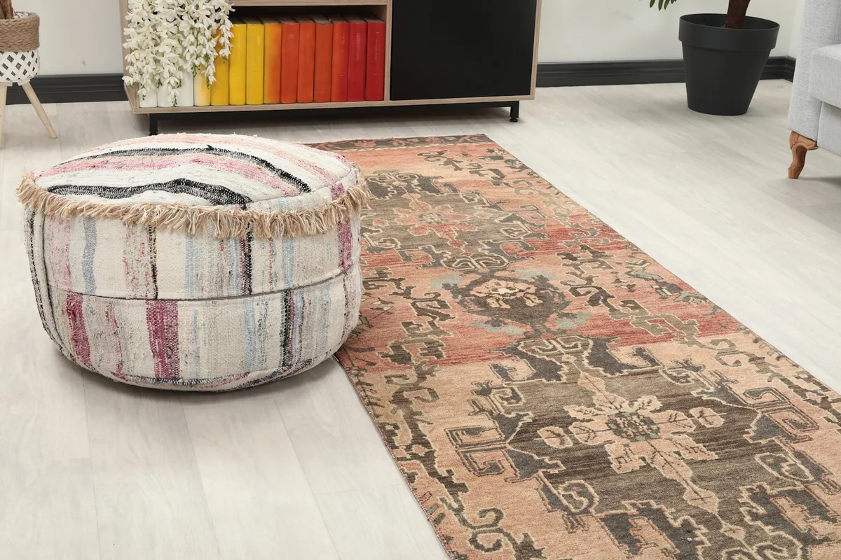 Close-up view of the runner's pattern and texture next to a pouf