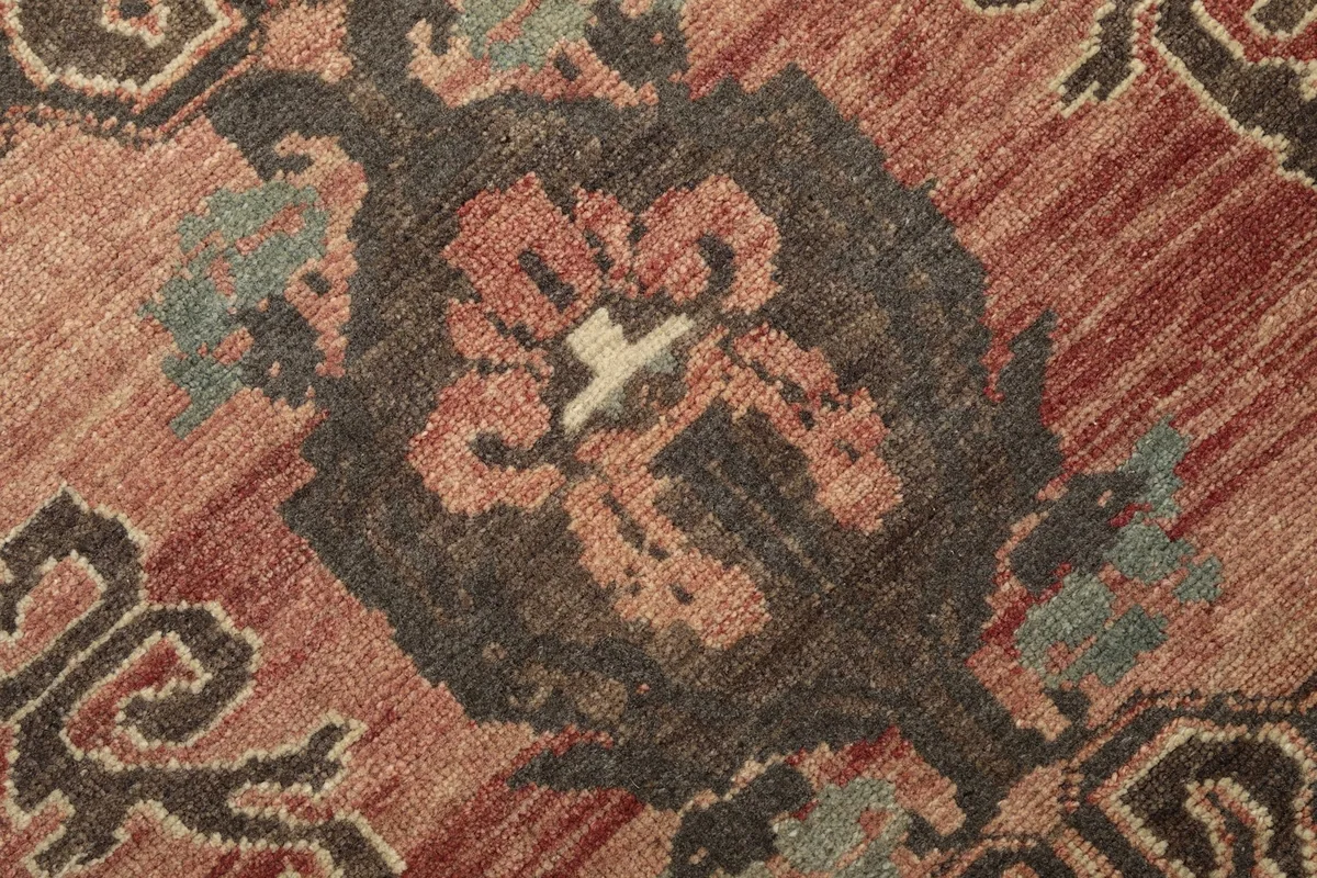 Extreme close-up of a central motif, highlighting the wool pile and knotting