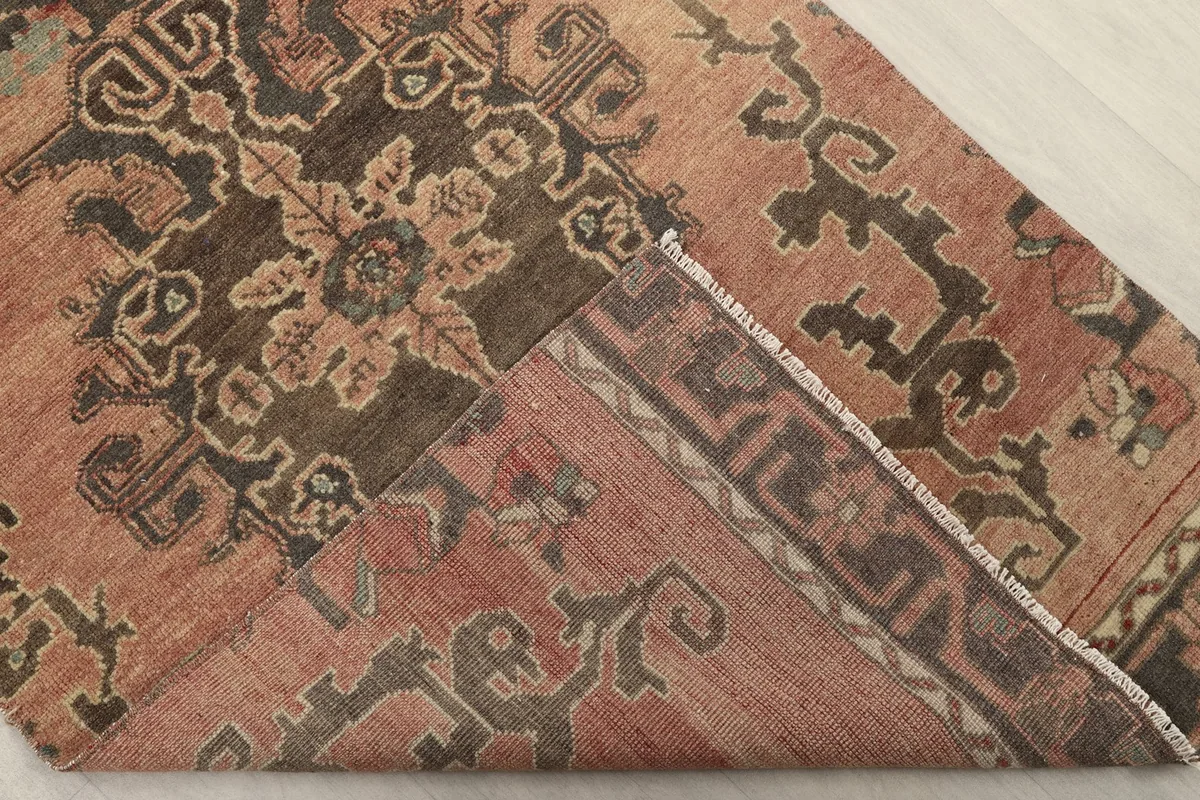 Folded corner showing the back of the rug and the tightly woven cotton foundation
