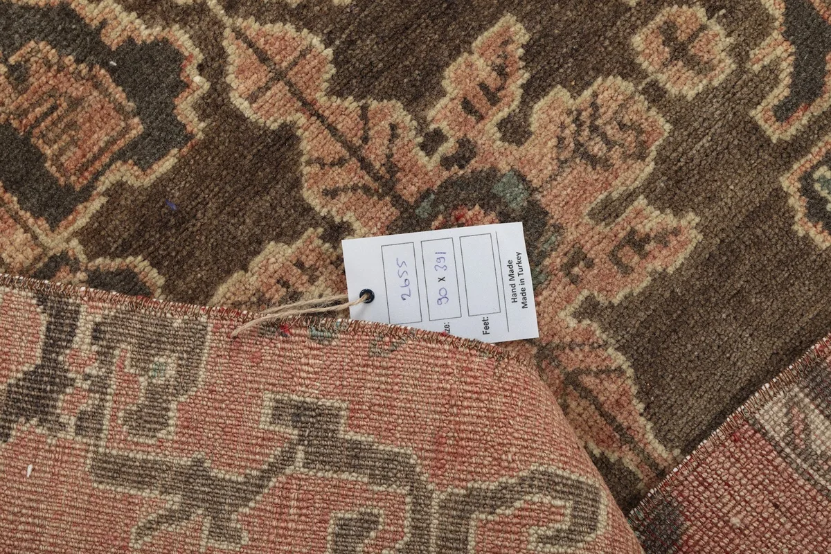 Close-up of the rug label and the back of the hand-knotted wool pile