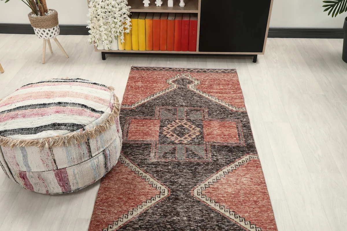 Overhead view of the runner rug in a room, focusing on the central patterns and surrounding elements