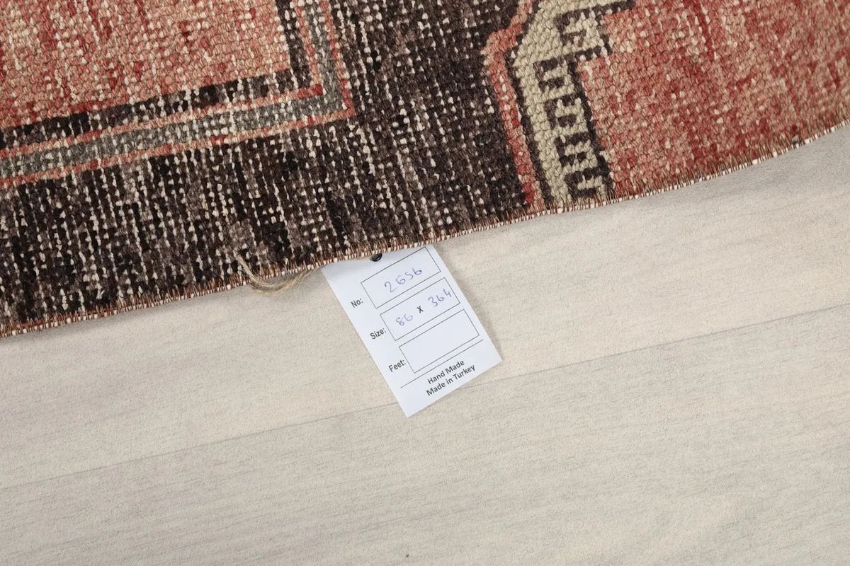 Corner of the rug with a product tag, indicating its origin and material details