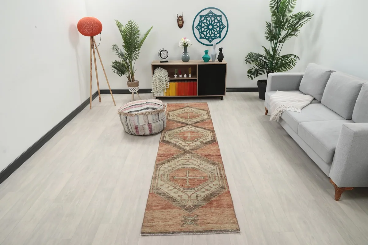 Vintage Anatolian runner rug laid out in a modern living space with light flooring and furniture.