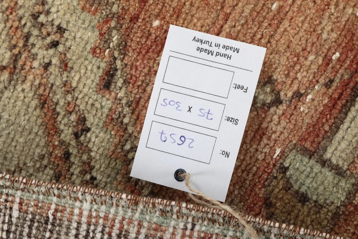 Close-up of the rug's label, indicating its size and handmade origin in Turkey.