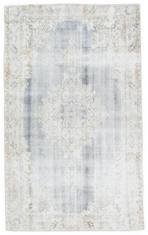 Full overhead view of the Faded Gray Floral Medallion vintage Anatolian rug on a white background