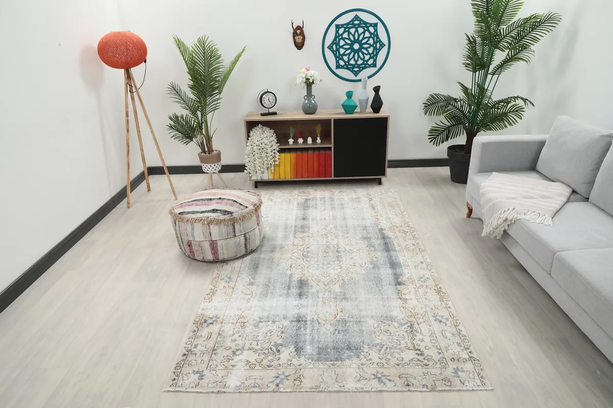 Vintage Anatolian rug displayed in a bright room setting with light wood floors and modern furniture