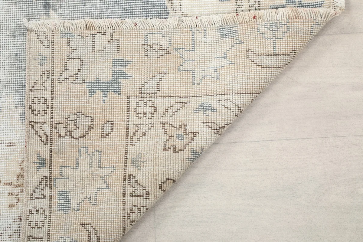 Another view of the rug's reverse side, showing the construction and fringe details