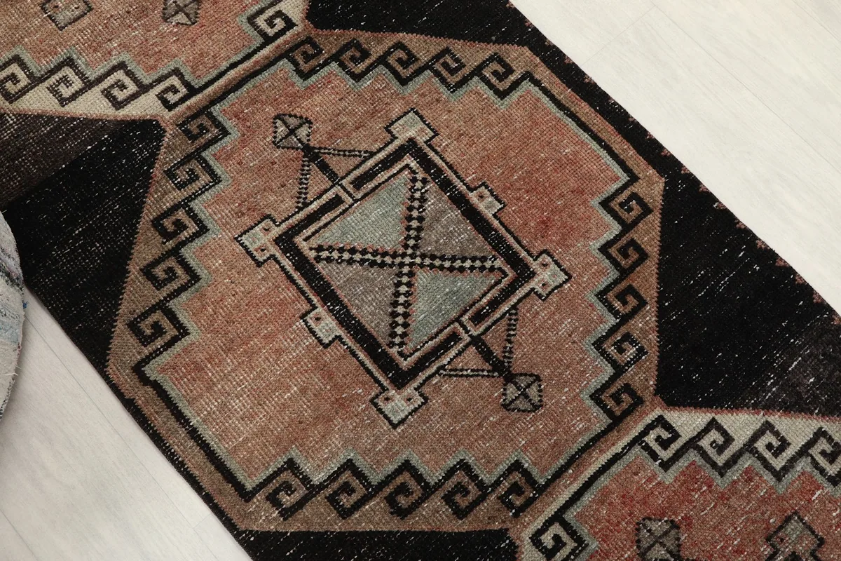 Overhead angled shot highlighting the central geometric motifs and the black border