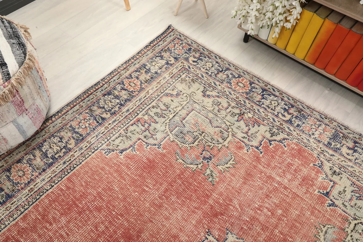 Corner angle view of the rug, capturing the border design and part of the main field
