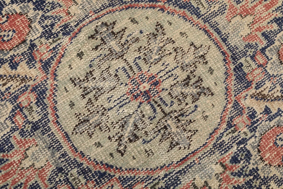 Detailed view of the central part of the medallion, showing the hand-knotted wool pile and subtle color variations