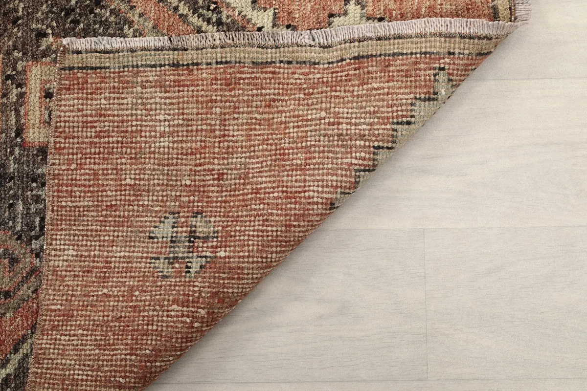 Close-up of the rug's back and the hand-knotted cotton foundation structure.
