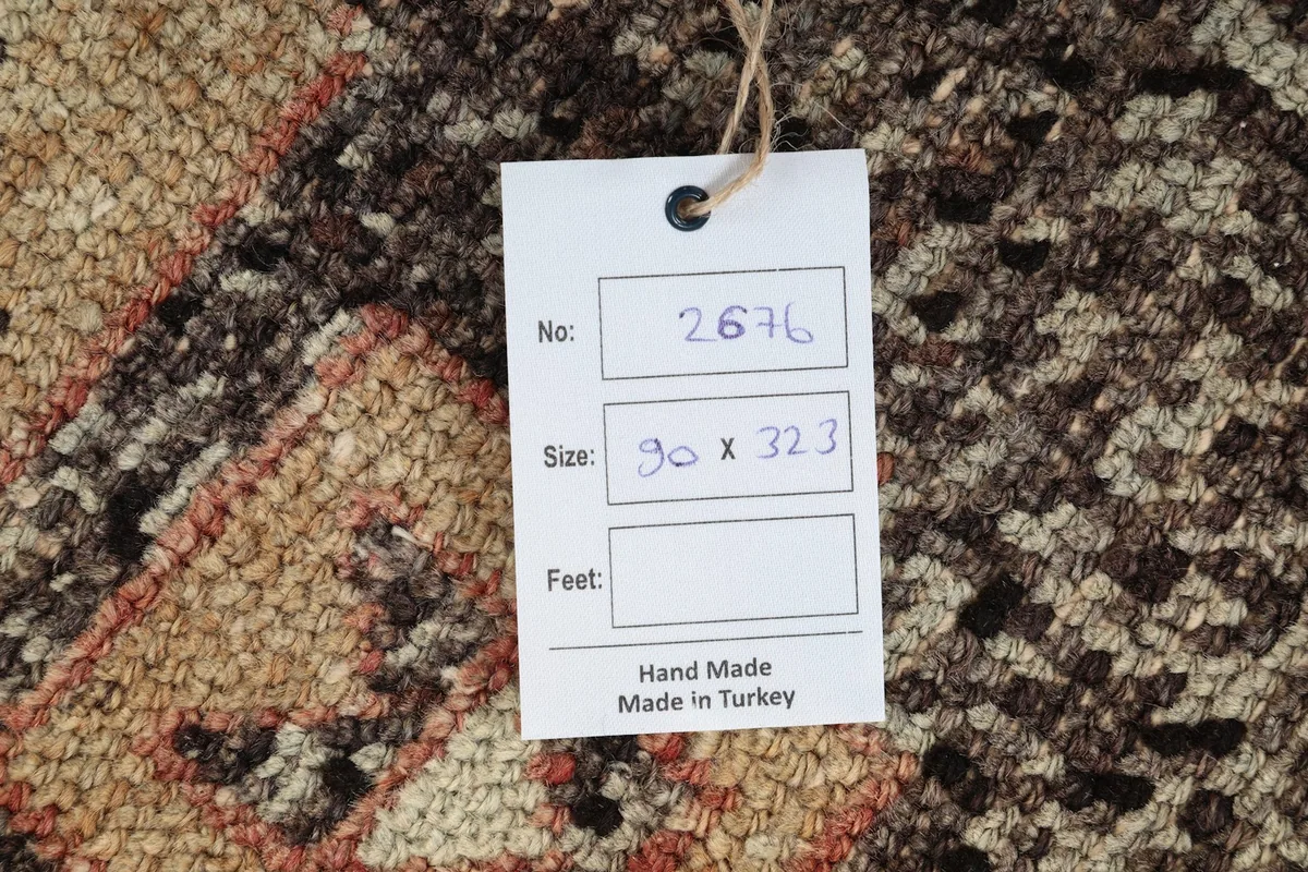 Tag showing the rug's identification number, size in centimeters, and origin: Hand Made in Turkey.