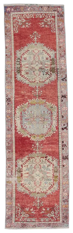 Full top view of the 2'5" x 10'8" red Anatolian runner with three medallions on a white background