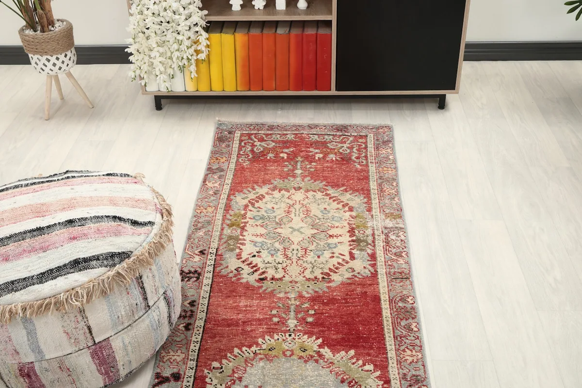 Overhead view of the red runner rug in a room, showcasing its full length and placement with furniture