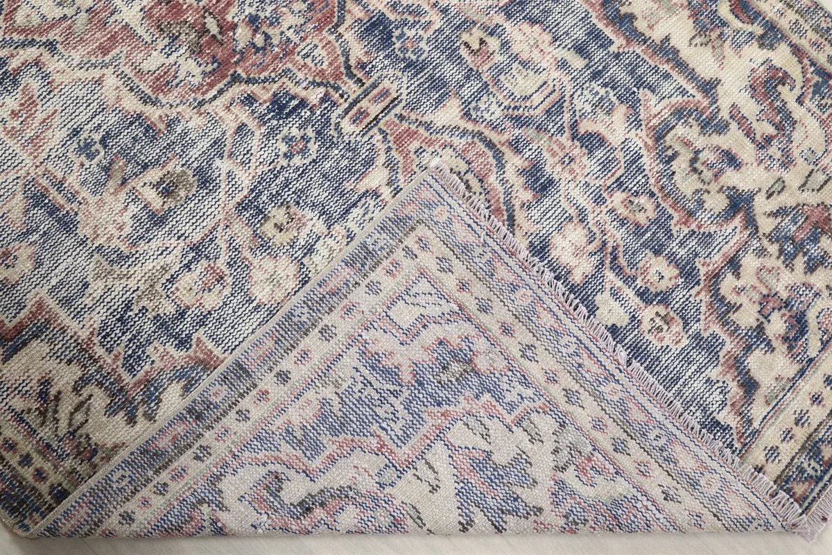 Underside of the rug, folded to reveal the hand-knotted cotton foundation