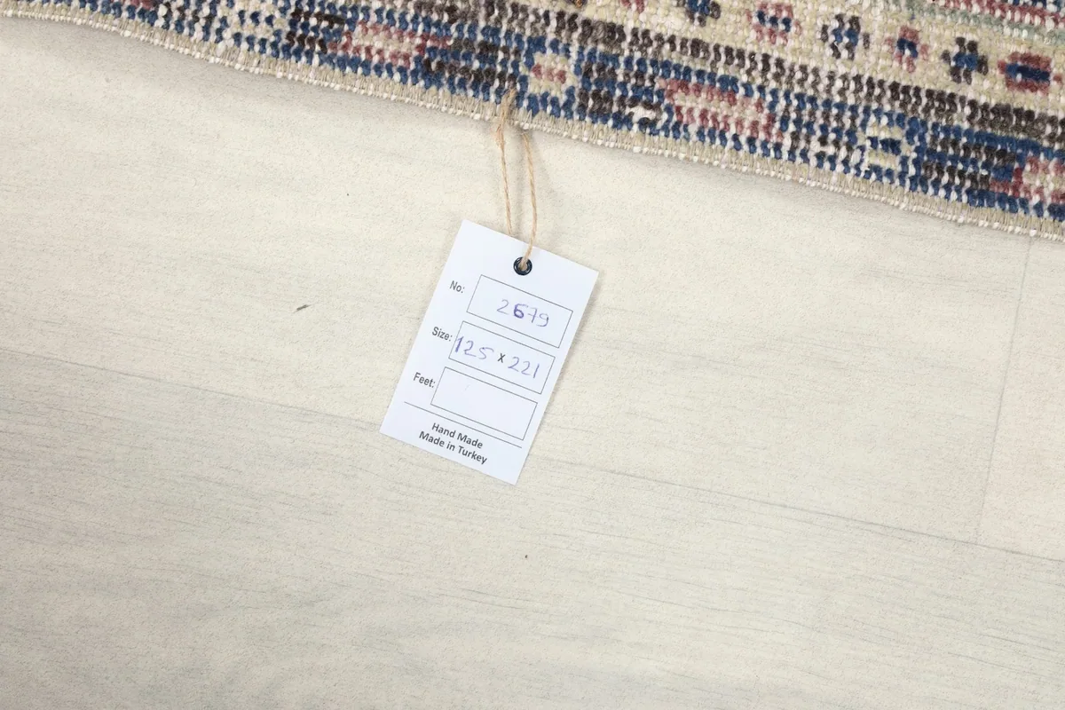 Tag attached to the rug displaying its unique product number and size