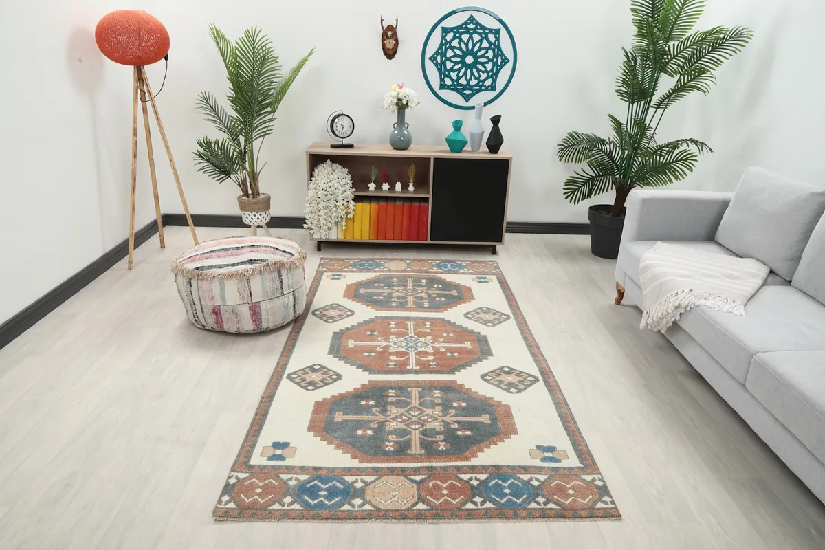 Vintage Anatolian rug displayed in a living room setting, seen from a distance