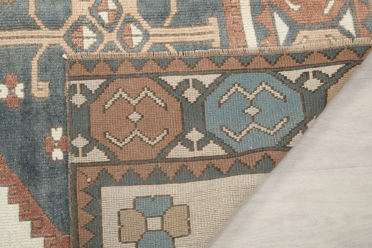 Close-up of the rug's reverse side, revealing the tight hand-knotting and border details