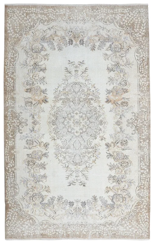 Full overhead view of the 5'8" x 9'2" cream and tan vintage Anatolian rug with floral medallion design