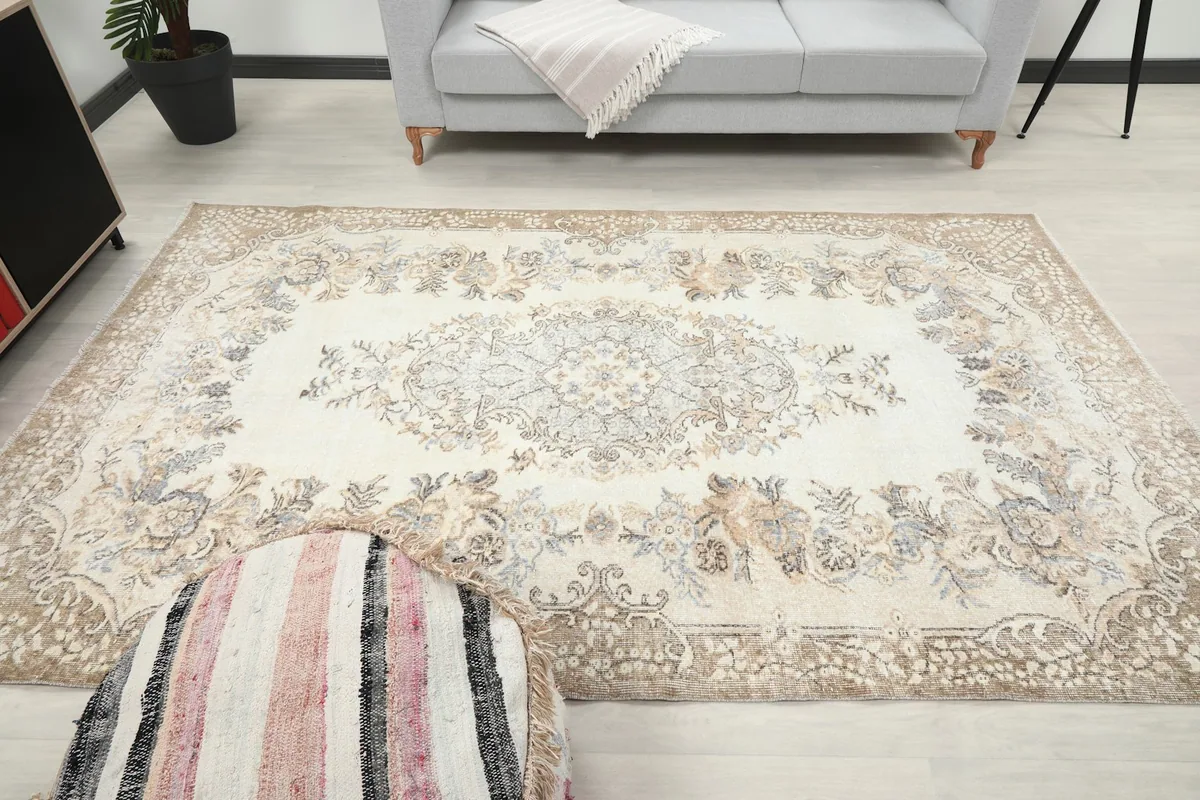 Wide shot of the rug in a room, providing context for its medium size and decorative impact