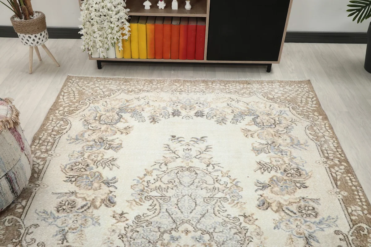 Overhead view of the top section of the rug, showing the border and upper floral motifs