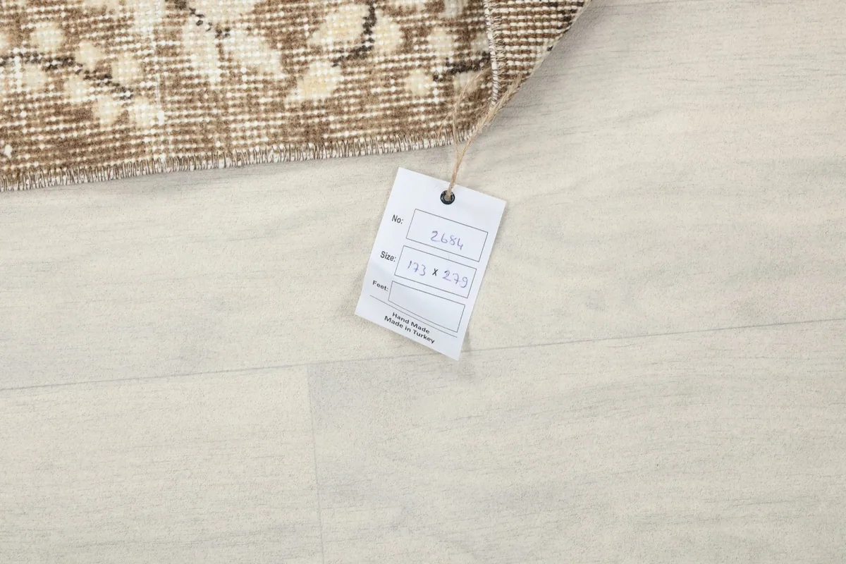 Product tag attached to the rug, displaying size and identification information