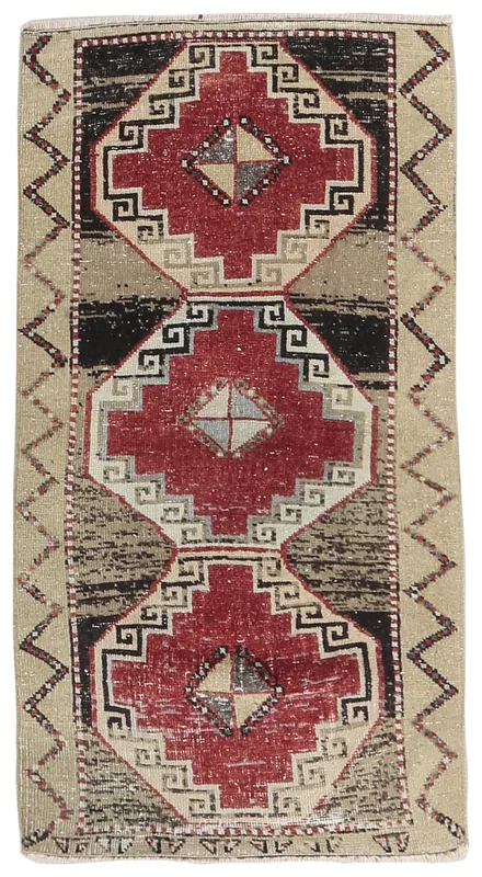 Full top view of the 2'6" x 5'3" vintage Anatolian rug with red and beige geometric patterns