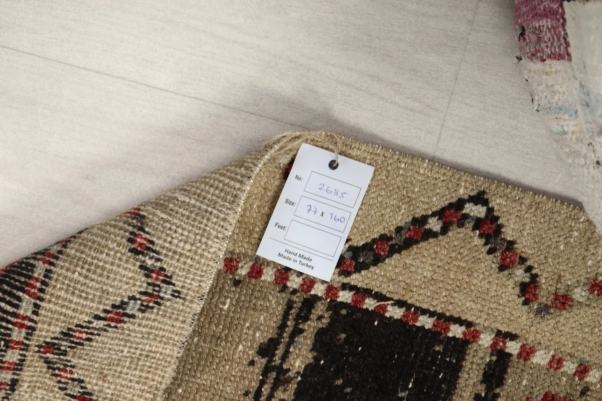 Tag attached to the rug, indicating its origin and size specifications