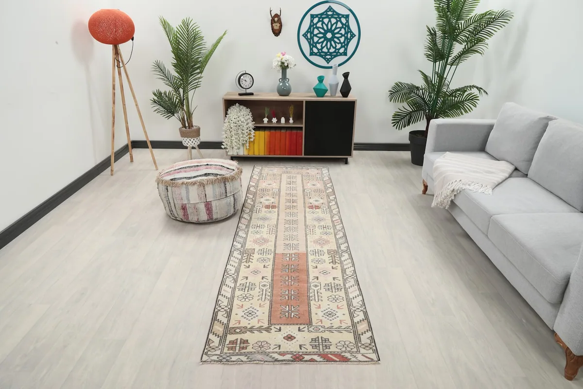 Vintage runner rug laid out in a living room setting, viewed from a distance