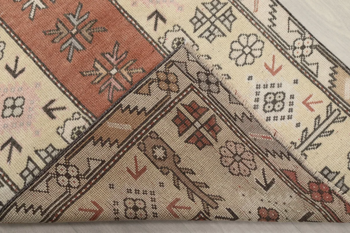Folded corner of the rug, revealing the back of the hand-knotted wool and cotton foundation