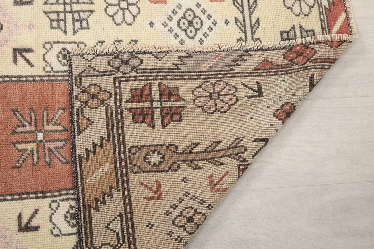 Another view of a folded corner, showing the rug's construction and texture from the reverse side