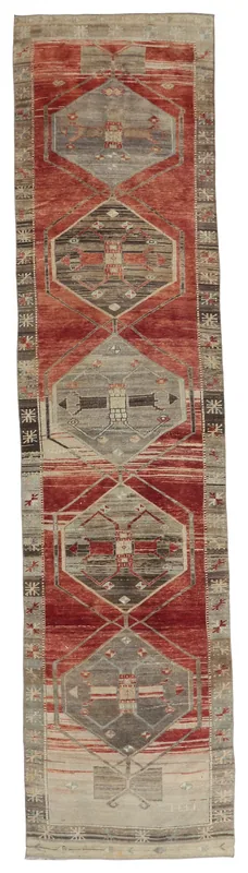 Full top view of the red and gray geometric runner rug on a white background