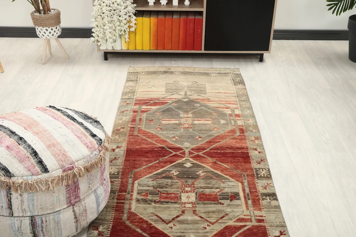 Runner rug extending from a living area towards a bookshelf, showing its length