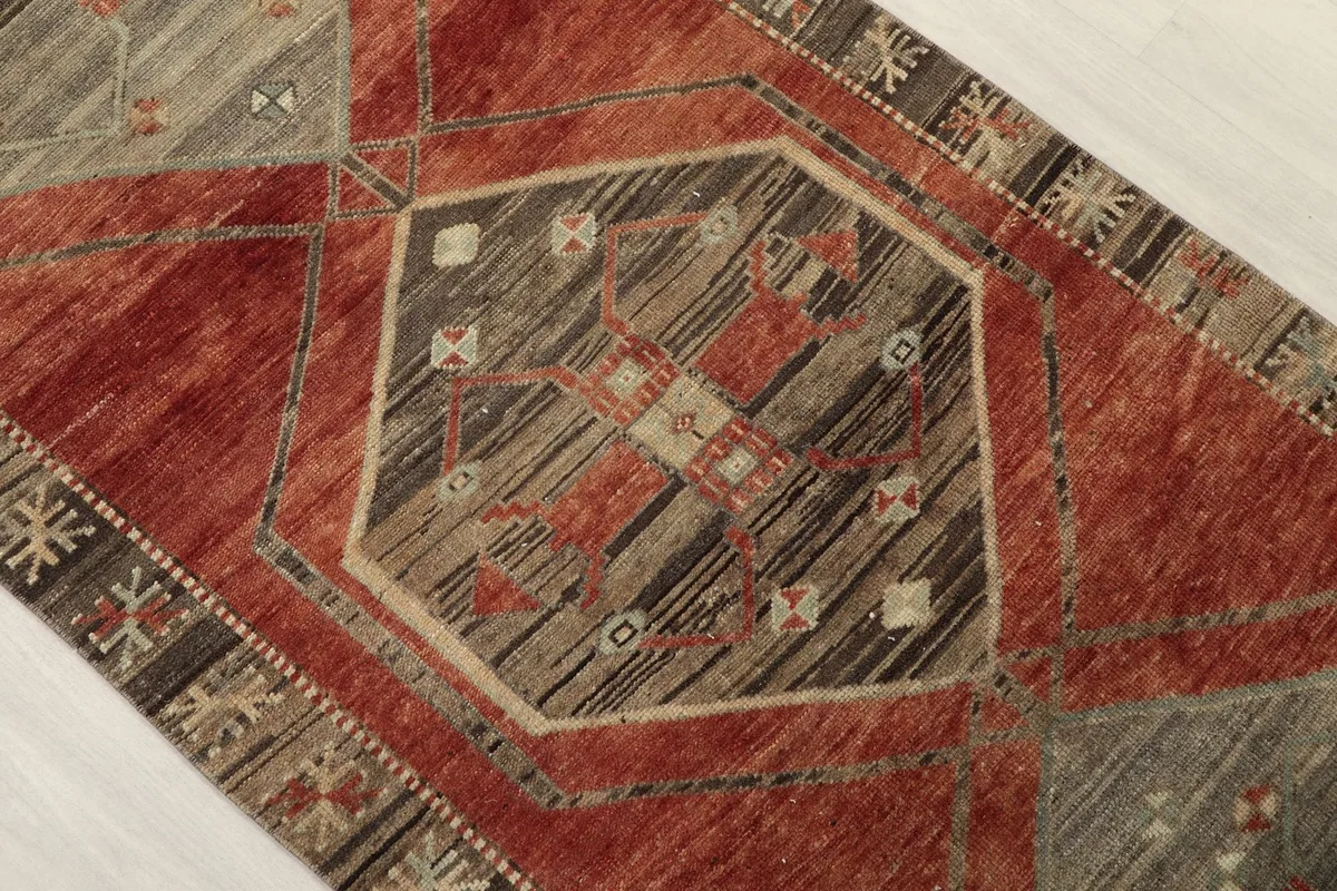 Close-up of a central geometric motif within the runner rug, showing color variations