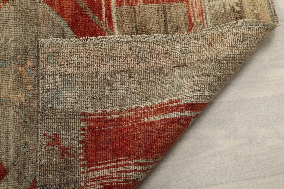 Underside of the runner rug, showing the hand-knotted cotton foundation