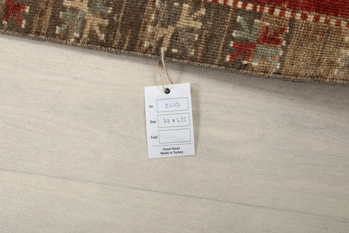 Close-up of the product tag attached to the runner rug, displaying size and origin