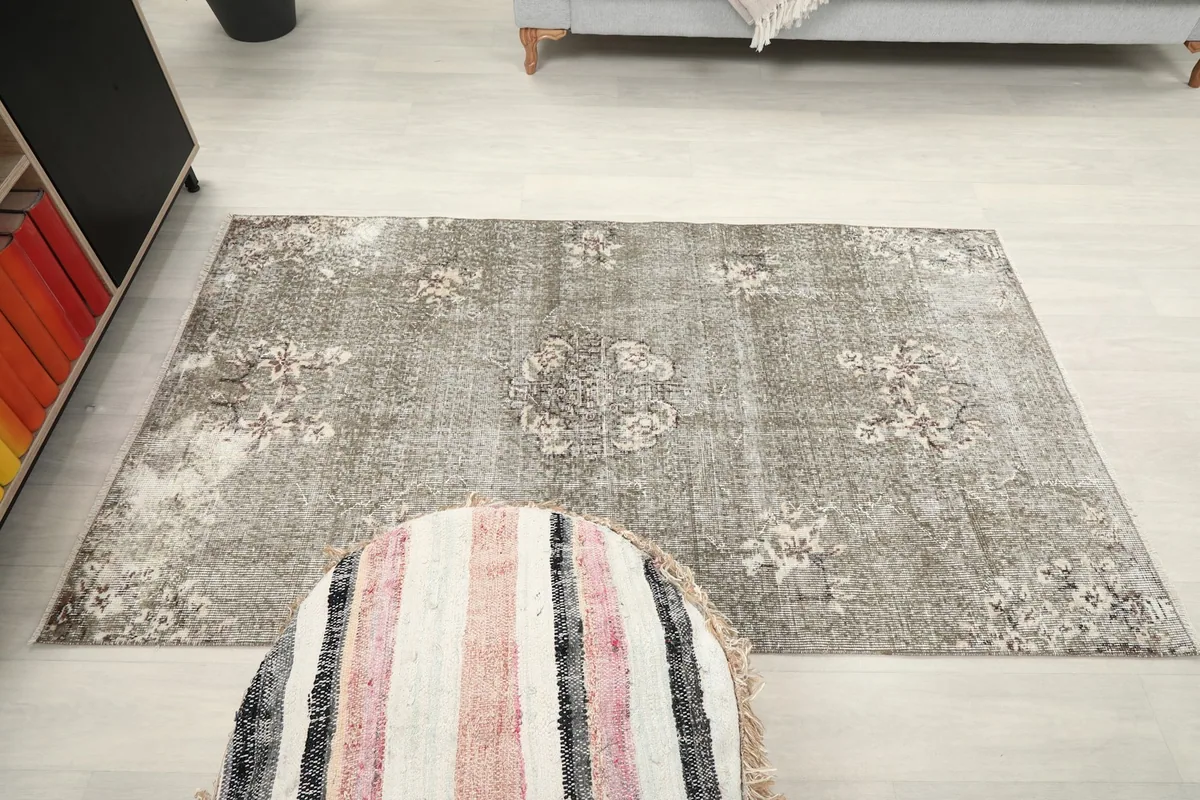 Full overhead view of the gray floral rug in the room, emphasizing its small area rug size.