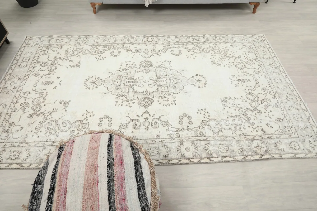 Direct overhead view of the rug, showing its symmetrical design and the distribution of cream and gray colors.