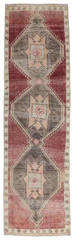 Full top view of the rust, gray, and beige geometric Anatolian runner on a white background.