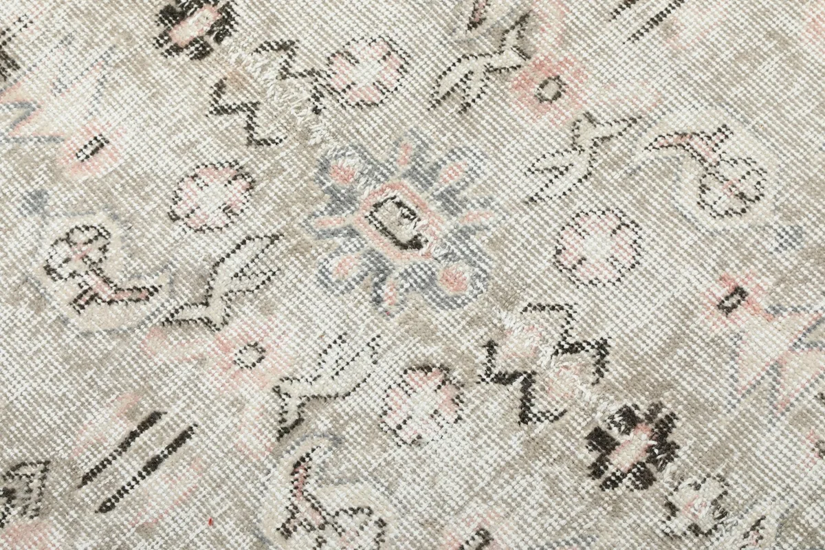 Extreme close-up showing the low wool pile and the texture of the hand-knotted construction.