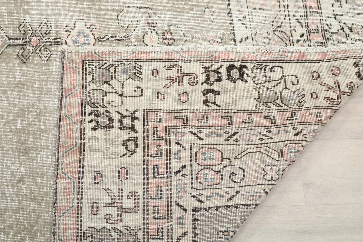 Close-up of the rug's back, showing the tight knotting and craftsmanship near the border.