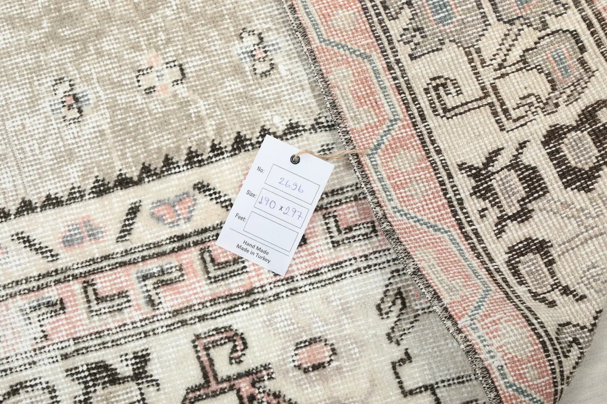 Detail showing the rug's back with a tag indicating its origin and size.