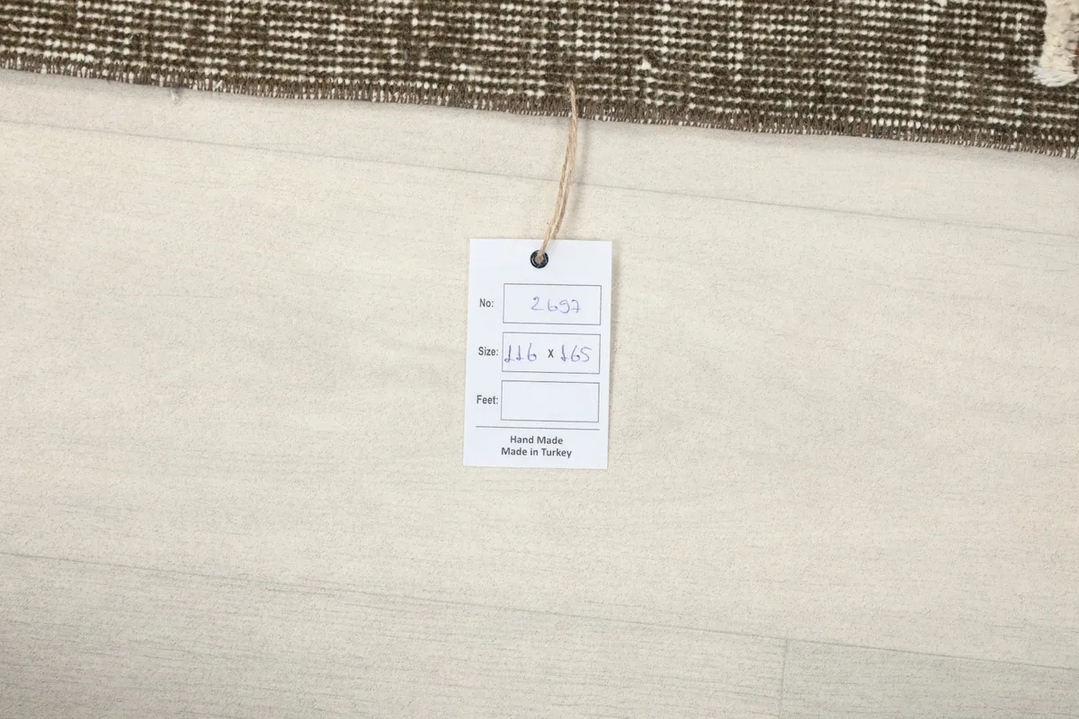 Product tag with size information and 'Hand Made in Turkey' on a light floor