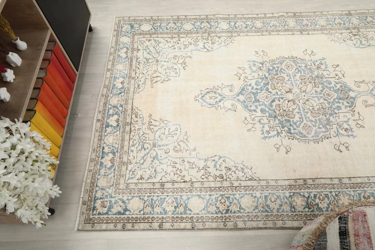 Overhead angle view of the rug in a room, emphasizing its full design and colors.