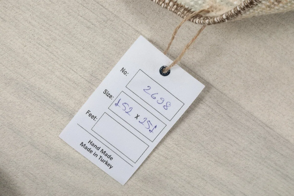 Product tag on the rug showing size 152 x 251 cm and 'Hand Made in Turkey'.